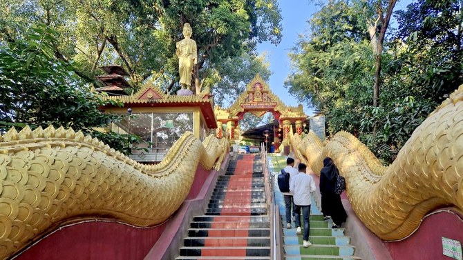 Tourists climb the stairs of Rangkut Monastery, the oldest Buddhist monastery in Bangladesh, located in Ramu, Coxs Bazar, on Dec. 29, 2023. (AN photo)